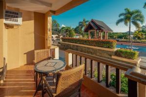 a patio with a table and chairs on a balcony at Coron Westown Resort in Coron