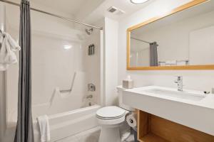 a white bathroom with a sink and a toilet at Sun Lodge, an Ascend Collection Hotel in Peru +119 photos