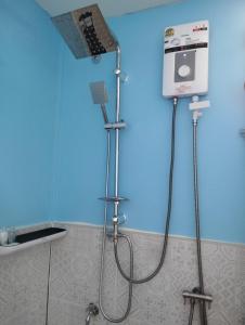 a shower in a bathroom with a blue wall at The Nap Koh Yao Yai in Ban Nai Wat +27 photos