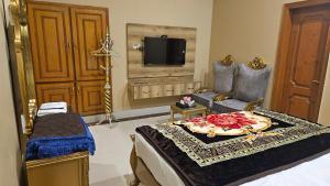 a room with a bed and a tv in a room at Hotel Destination in Sukkur