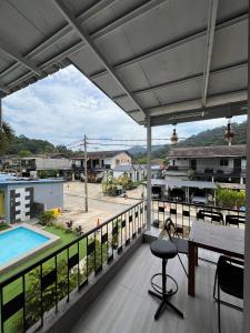 a balcony with a table and chairs and a pool at TC Maya Abaya Hotel in Kuantan