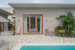 a villa with a swimming pool and a house at Tayo Villa in Ahangama