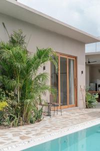 a villa with a swimming pool and a house at Tayo Villa in Ahangama