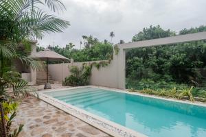 a swimming pool in the backyard of a house at Tayo Villa in Ahangama +10 photos