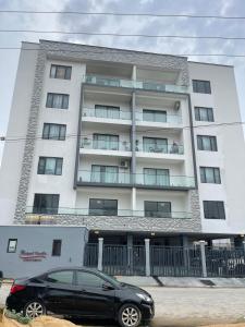 a black car parked in front of a building at Tiny Studio Apartment with Pool and gym in Lekki