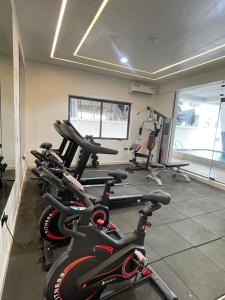 a gym with a bunch of exercise bikes in a room at Tiny Studio Apartment with Pool and gym in Lekki