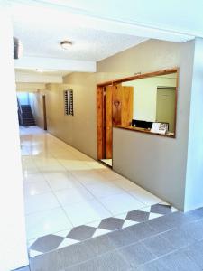 an empty room with a hallway with a mirror at Red Palm Hotel in Suva
