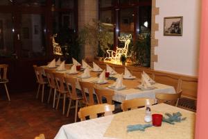a row of tables and chairs in a restaurant at Gasthof Hausmann in Schlüchtern