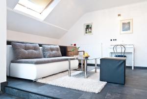 a living room with a couch and a table at Landhotel Rauber Sankt Wendel in Oberthal