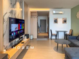 a living room with a large flat screen tv at SB1B4P Hozem SA B46 Roxy Sematan in Sematan