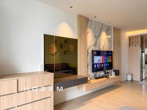 a living room with a flat screen tv on a wall at SB1B4P Hozem SA B46 Roxy Sematan in Sematan