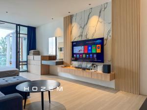 a living room with a flat screen tv on a wall at SB1B4P Hozem SA B46 Roxy Sematan in Sematan