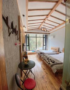 a bedroom with a bed and a table in a room at 莫干山后舍民宿 in Deqing +59 photos