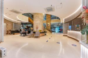 a lobby of a building with people sitting at a table at Crown Regency Hotel & Towers in Cebu City +133 photos