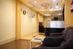 a waiting room with a couch and a table at Hotel Sri Ram in Similigurha