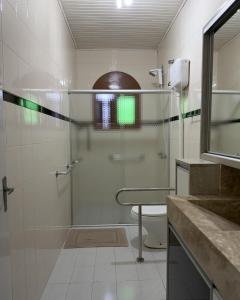 a bathroom with a glass shower and a toilet at Casa Bella Vita in Pinto Bandeira +13 photos