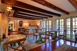 a dining room with tables and chairs at The Baker House 1650 in East Hampton