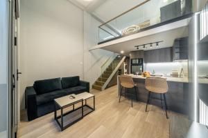 a living room with a couch and a table at Aster Apartments - Stylish Loft with Rooftop Pool & Sauna in Canggu +40 photos