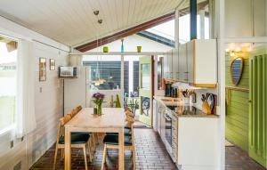 a kitchen with a wooden table and chairs at Golfparken in Aabenraa
