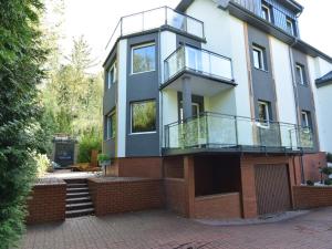 an image of a house with a balcony at Comfortable Jacuzzi Apartment for 8 in Stezyca in Stężyca