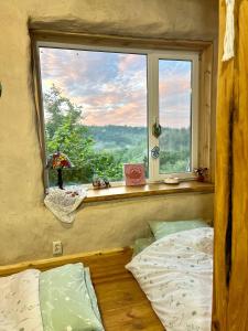 a bedroom with a window and a bed in front of it at Простір Джерело Гармонії in Kaniv