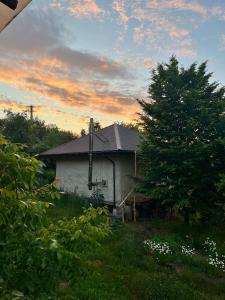 a white house with a tree and a cloudy sky at Простір Джерело Гармонії in Kaniv +15 photos