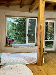 a bedroom with a bed in front of a window at Простір Джерело Гармонії in Kaniv
