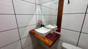 a bathroom with a sink and a toilet at Pousada Moaçara in Estivado +32 photos