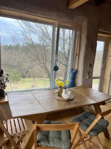 a wooden table in a room with a large window at Простір Джерело Гармонії in Kaniv