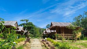 a group of bamboo huts in a village at Mook Mellow Hill Bungalows in Ko Mook
