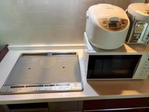 a counter with a food processor and a scale on it at YAMAYA BASE 2 in Miyoshi +18 photos