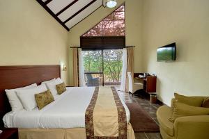a bedroom with a large bed and a window at Sagana Getaway Resort in Maranjua