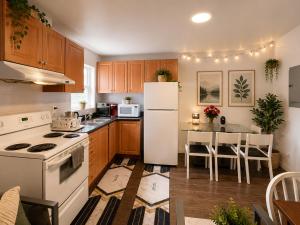 a kitchen with a white refrigerator and a table at ChinaTown Boutique Rooms in Toronto
