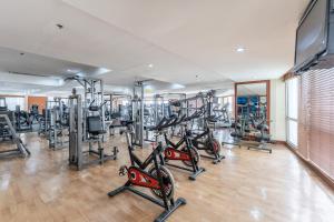 a gym with several treadmills and elliptical machines at Crown Regency Hotel & Towers in Cebu City