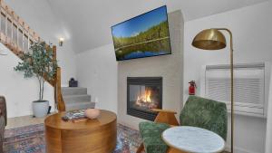 a living room with a fireplace and a tv at Waterfront, Hot Tub, Dock Kayaks, Movie Game Room in Lake Ariel