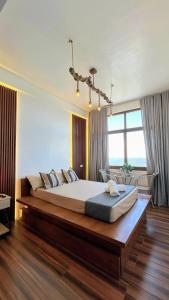 a bedroom with a large bed in a room at Speranza Hotel & Restaurant in Infanta