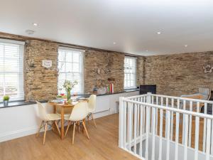 a dining room with a table and chairs at Dayan Cottage in Fowey