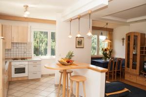 a kitchen with a island with a table and chairs at Residence Wiesenheim in Trodena