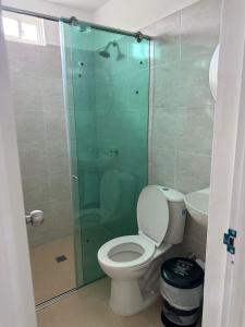 a bathroom with a toilet and a glass shower at Hostal La Marina in Santa Marta +24 photos