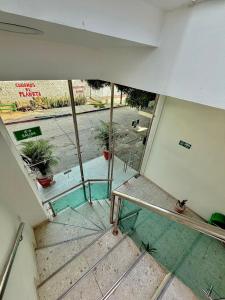 an empty room with a staircase with a window at Hostal La Marina in Santa Marta