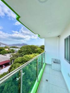 a room with a balcony with a view at Hostal La Marina in Santa Marta