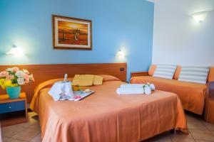 Postel nebo postele na pokoji v ubytování Hotel Bacco