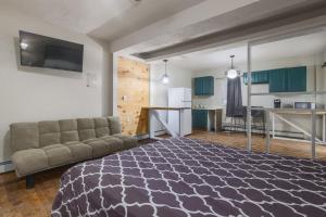 a living room with a couch and a kitchen at Rustic Private Studio Near Downtown Worcester in Worcester
