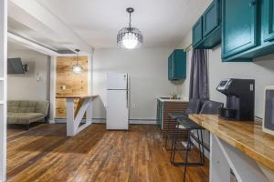 a kitchen and living room with a refrigerator and a table at Rustic Private Studio Near Downtown Worcester in Worcester