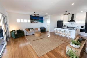 a large living room with a couch and a kitchen at Quampi House with Best Ocean View in Point Lookout