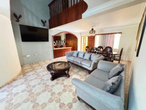 a living room with a couch and a table at Hotel1325 in Baní