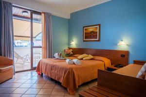 Postel nebo postele na pokoji v ubytování Hotel Bacco