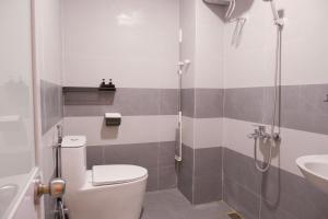 a bathroom with a toilet and a shower and a sink at Ni Nớ Home in Hue +30 photos