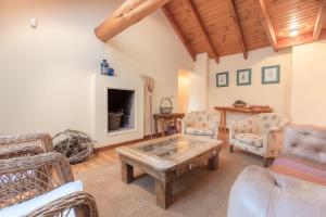 sala de estar con mesa de centro y chimenea en BOG Casa Ciprés, en Villa La Angostura