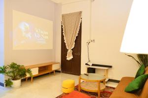 a living room with a couch and a table at Ni Nớ Home in Hue
